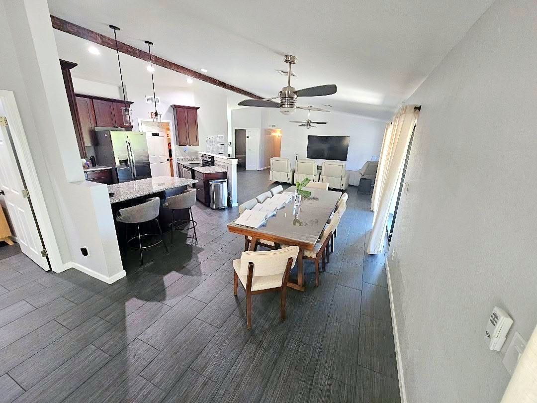Open kitchen and dining area with a long wooden table